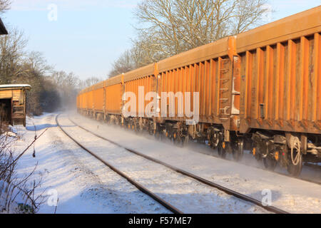 diesel freight locomotive traveling through snow between Melton Mowbray Leicestershire and Oakham Rutland UK Stock Photo