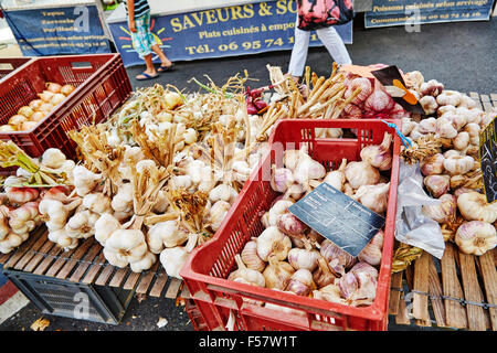 Street market stall in Objat, France selling garlic. Stock Photo