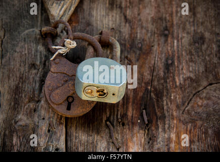 Close-up details  of two metal rusty padlocks on a closed old vintage wooden door Stock Photo