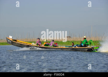 Tourists riding in a long-tail boat across Inle Lake, Shan State, Myanmar (Burma) Stock Photo