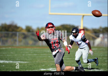 Pass receiver working on an an out route in an effort to make a reception in front of an opposing defensive back. USA. Stock Photo