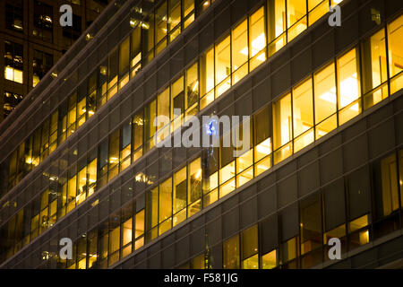 Modern office building with windows lit up at night Stock Photo