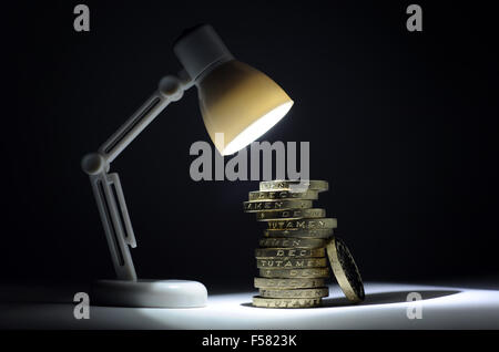 SPOTLIGHT SHINING ON STACK OF ONE POUND COINS RE SAVINGS INVESTMENTS INCOMES WAGES HOUSEHOLD BUDGET PRIVATE PENSION MORTGAGES UK Stock Photo