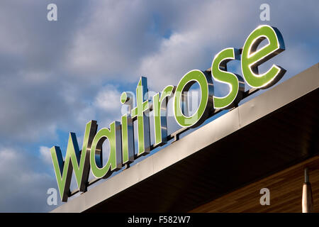 A Waitrose sign on a store front in the sunlight. Stock Photo