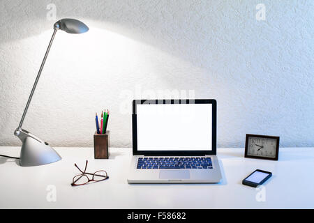 office workplace of business person, table with laptop and lamp Stock Photo
