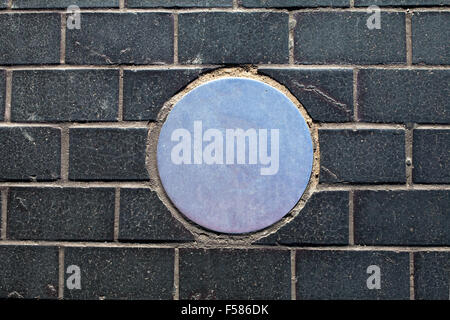 brick background with metal circle Stock Photo
