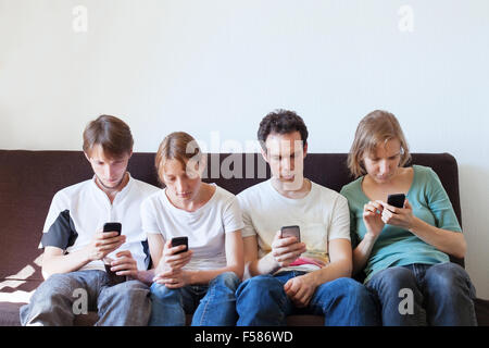 internet addiction, group of young people looking at their smart phones Stock Photo