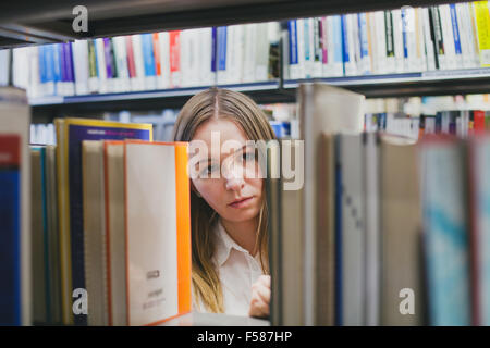 girl student choosing book in the library