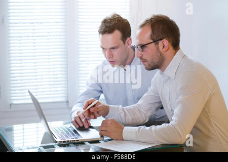 two business men working on laptop, learning new Stock Photo
