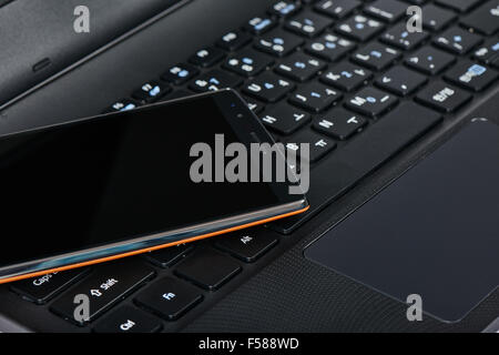 closeup of smartphone on a korean keypad of laptop Stock Photo