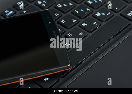 closeup of smartphone on a korean keypad of laptop Stock Photo