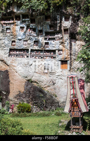 Traditional Tao Tao adorn a cliff face at Lemo Village in Sulawesi, Indonesia Stock Photo