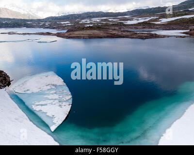 Sheet of ice are floating in the glacial lake 'Totensee' on top of the Grimsel pass, Switzerland (altitude 2165m). Stock Photo