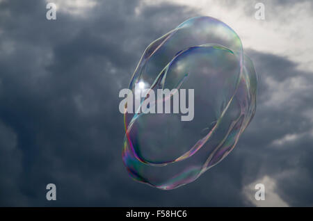 Large isolated soap bubble isolated against stormy sky Stock Photo