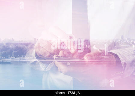 Double exposure of businessman hands with mobile smart phone, finger on touch screen of wireless device, cityscape in background Stock Photo