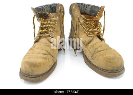 Old dirty yellow working boots isolated on white Stock Photo