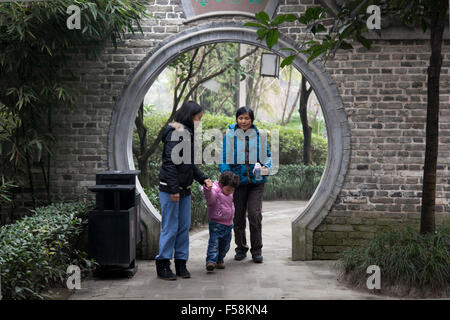 Three generations of Chinese women strolling in an old garden at an old town called Pixian at the outskirts of Chengdu in China. Stock Photo