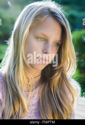 Smiling blonde teen girl 14-16 year old wearing stylish clothes posing  outdoors. Looking at camera. Autumn season Stock Photo - Alamy