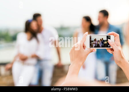 Young and beautiful couples taking photos with smartphone Stock Photo