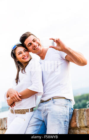 Young beautiful couple taking a selfie of themselves and being happy