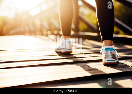 Beautiful female runner jogging in nature Stock Photo