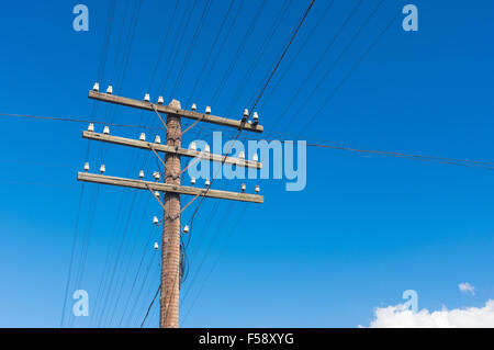 aged wooden pole for an electricity in rural Ukrainian area Stock Photo