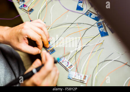 Hardware chips being fixed by soldering Stock Photo