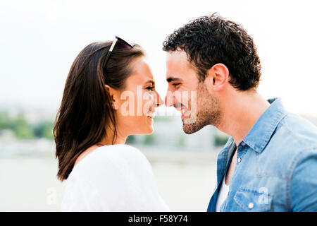 Young beautiful couple rubbing noses as a sign of love and about to kiss each other
