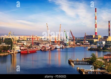 View wharf shipyard with high chimneys in the background in Gdansk, Poland. Stock Photo