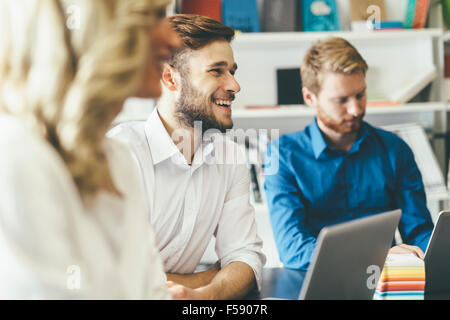 Cheerful coworkers in office during company meeting Stock Photo