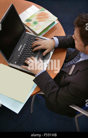 Top view of a businessman typing on his laptop. Stock Photo