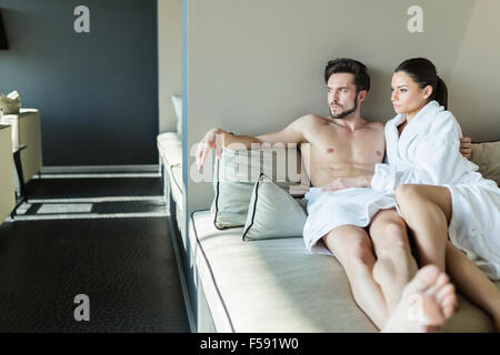 Lovely couple relaxing at a wellness center, laying in a rob and towel Stock Photo