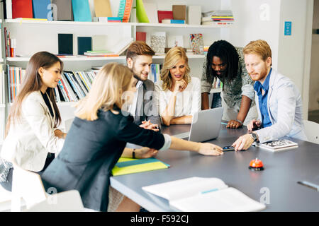 Team of skilled designers and business people working together on a project Stock Photo