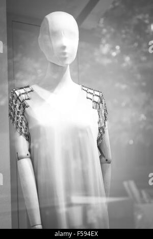 Shop bald dummy fashion mannequin in store boutique shop window