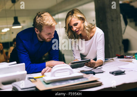 Two designers talking about possible trends ideas and new fashion styles. Teamwork Stock Photo