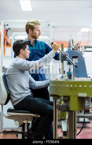 Two young students working on a science project together in lab Stock Photo