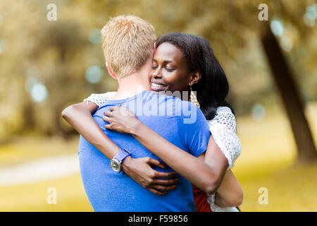 Couple in love hugging peacfully outdoors and being truly happy. Feeling of security and serenity Stock Photo