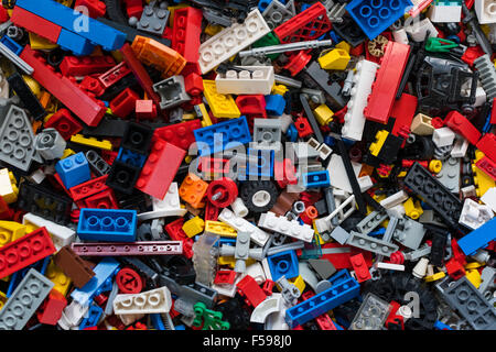 View from above into a box full of mixed colourful Lego bricks (multiple generations of Legos from 1970 till today) Stock Photo