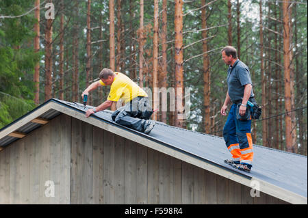 Workers on a roof Stock Photo
