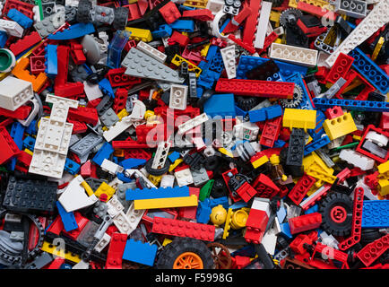 View from above into a box full of mixed colourful Lego bricks (multiple generations of Legos from 1970 till today) Stock Photo