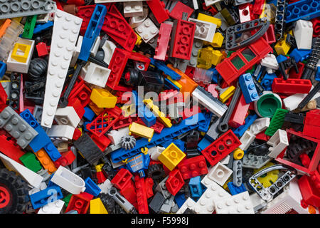 View from above into a box full of mixed colourful Lego bricks (multiple generations of Legos from 1970 till today) Stock Photo