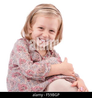 Cute little girl dressed in floral, dress having fun Stock Photo