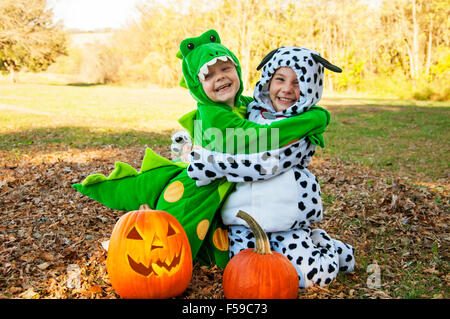 Two kids in costume hugging Stock Photo