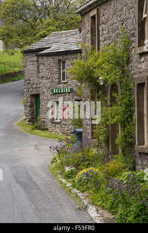 Traditional, stone-built, roadside cottages (with name sign & post box) in the quaint hamlet of Selside, Yorkshire Dales National Park, England UK. Stock Photo