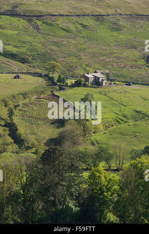Sunny, high view over the fells in the valley of Dentdale, Cumbria, England, UK - isolated farm & tractor working in a field on steep-sided hillside. Stock Photo
