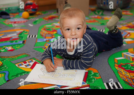 Cute, little boy paints a colorful picture (Shallow DOF). Stock Photo