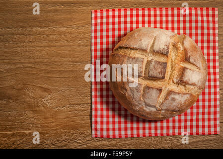 loaf of fresh homemade sour dough bread on wooden table Stock Photo