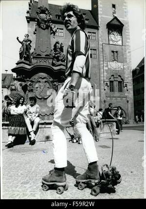 1972 - The Newest Craze On The Roller-Skate-Market: Skates With A Two Horse Power Motor! This young man have strapped on his feet the newest craze on the roller-skate-market: A motor propelled roller-skate. The skates are equipped with a little motor which do with it's two horse power motor a speed of about 20 km/h. The regulation of the speed can be done by a remote control. But it's not easy as it looks like, to use this novelty, the acceleration only on one foot needs a good sense of balance by the user. Ops: One of the first users of the propelled skates in the city of Wuerzburg/West-Germa Stock Photo