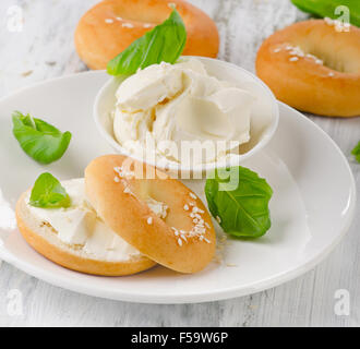 Fresh bagels with cream cheese for healthy breakfast. Selective focus Stock Photo