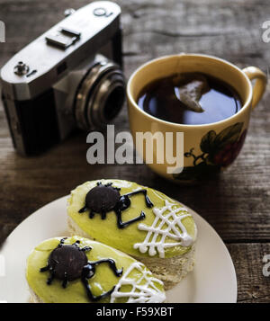 Oct. 30, 2015 - Cake on whie plate, cap of tea and retro camera on wooden weathering table © Igor Goiovniov/ZUMA Wire/Alamy Live News Stock Photo